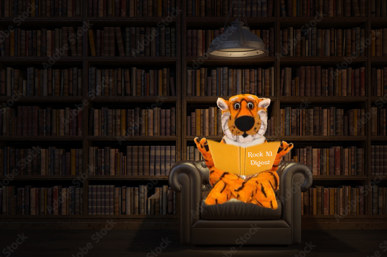 Truman the Tiger sitting under a lamp in a book-lined room, reading a book called “Rock M Digest”